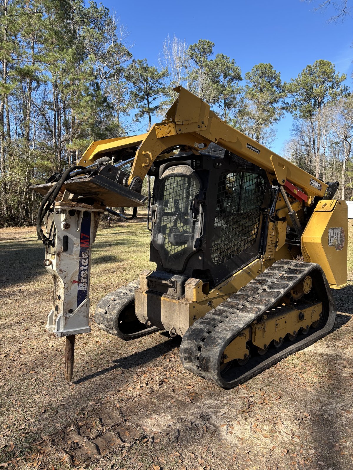 CAT 299D3 XE track loader with a Bretec hydraulic breaker for stubborn stumps