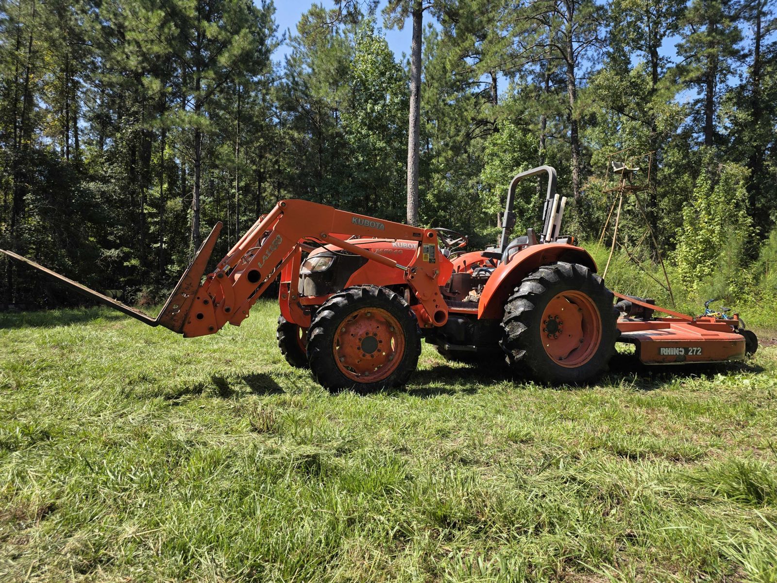 Kubota M5040 tractor with a 72-inch Rhino rotary cutter for bush hogging